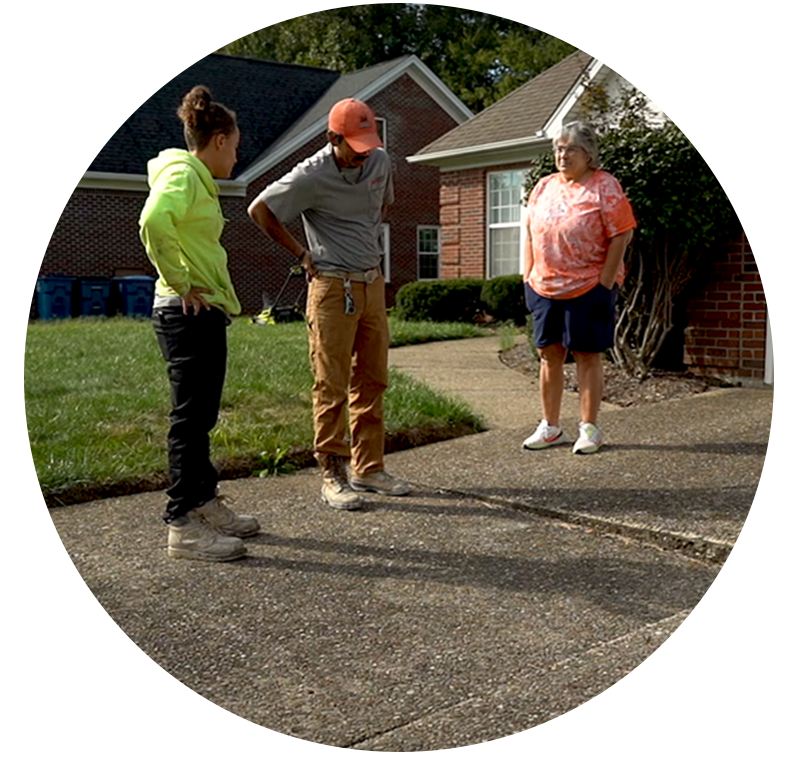 Group of people assessing concrete driveway