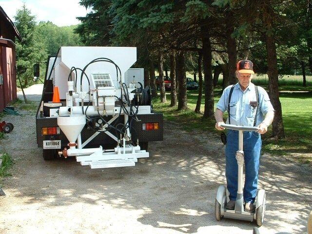 Grover Miller standing on segway next to concrete leveling truck