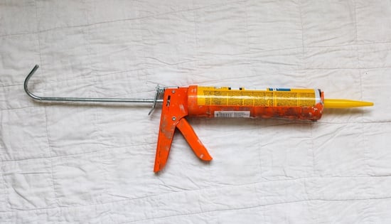 Cheap metal caulk gun with concrete caulk tube inside