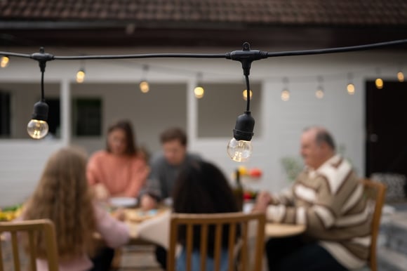 Family enjoying a meal on back patio