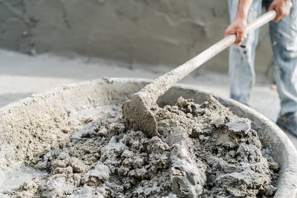 Person mixing concrete by hand