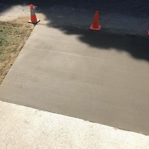 Newly poured concrete driveway slab that doesn't match existing slabs