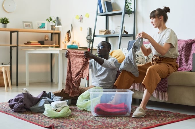 Couple organizing clothes in the living room