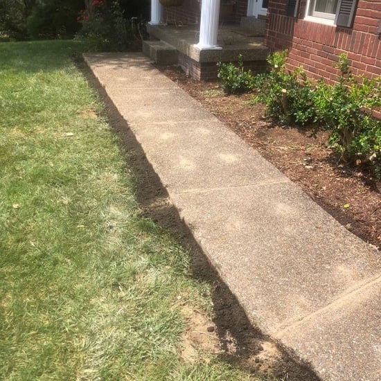 Soil added around the sides of concrete walkway