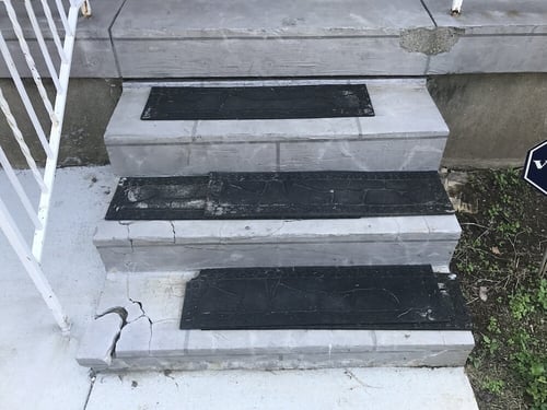 Concrete step with corner broken off