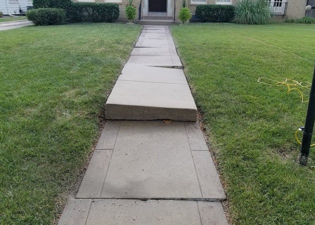 Uneven front walkway slabs leading to front porch