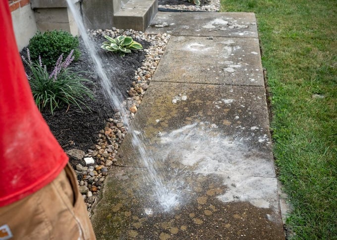 Washing limestone slurry off sidewalk