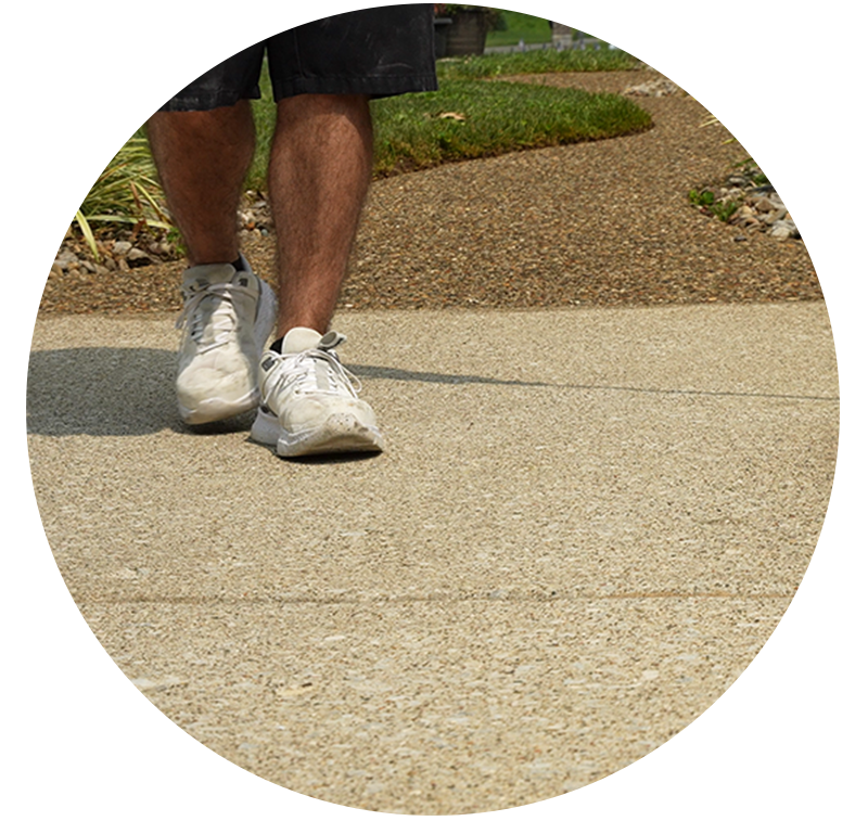 Man walking on clean concrete driveway