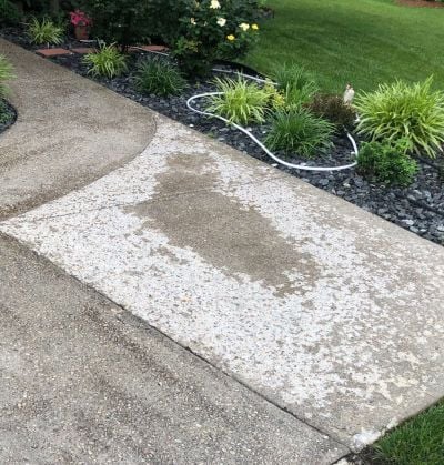 Concrete driveway with spalling surface damage